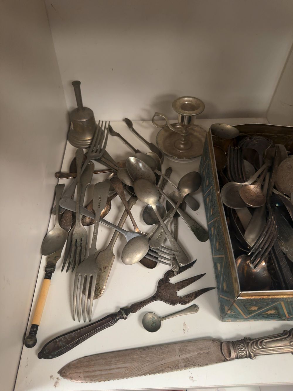 Lot 309: An Assortment of Silver-Plated Flatware and Tableware including a Chamberstick, Bread Knife and Decorative Tin