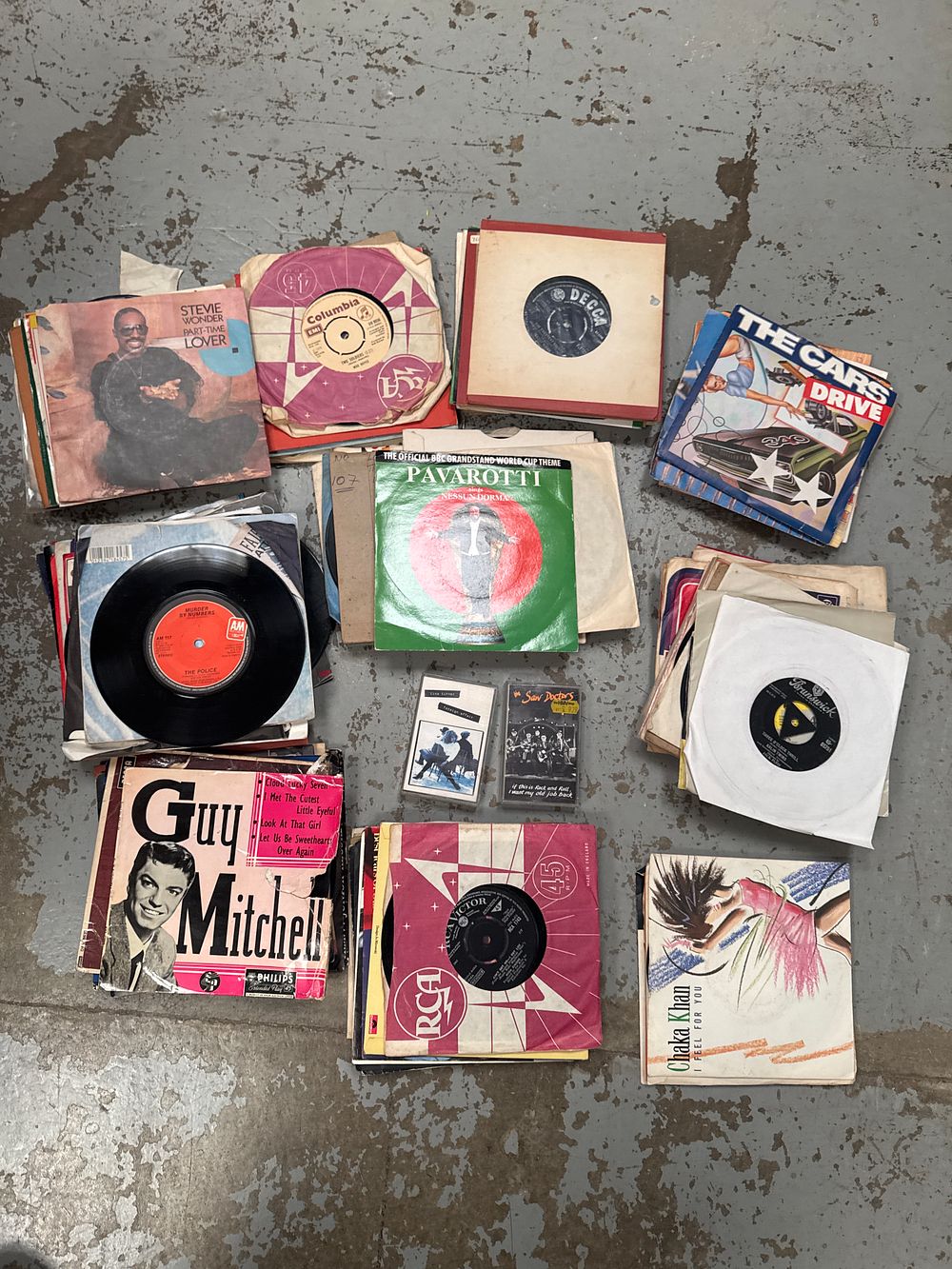 Lot 317: A Collection of 7-Inch Vinyl Singles and Cassette Tapes including The Cars, Chaka Khan and Stevie Wonder