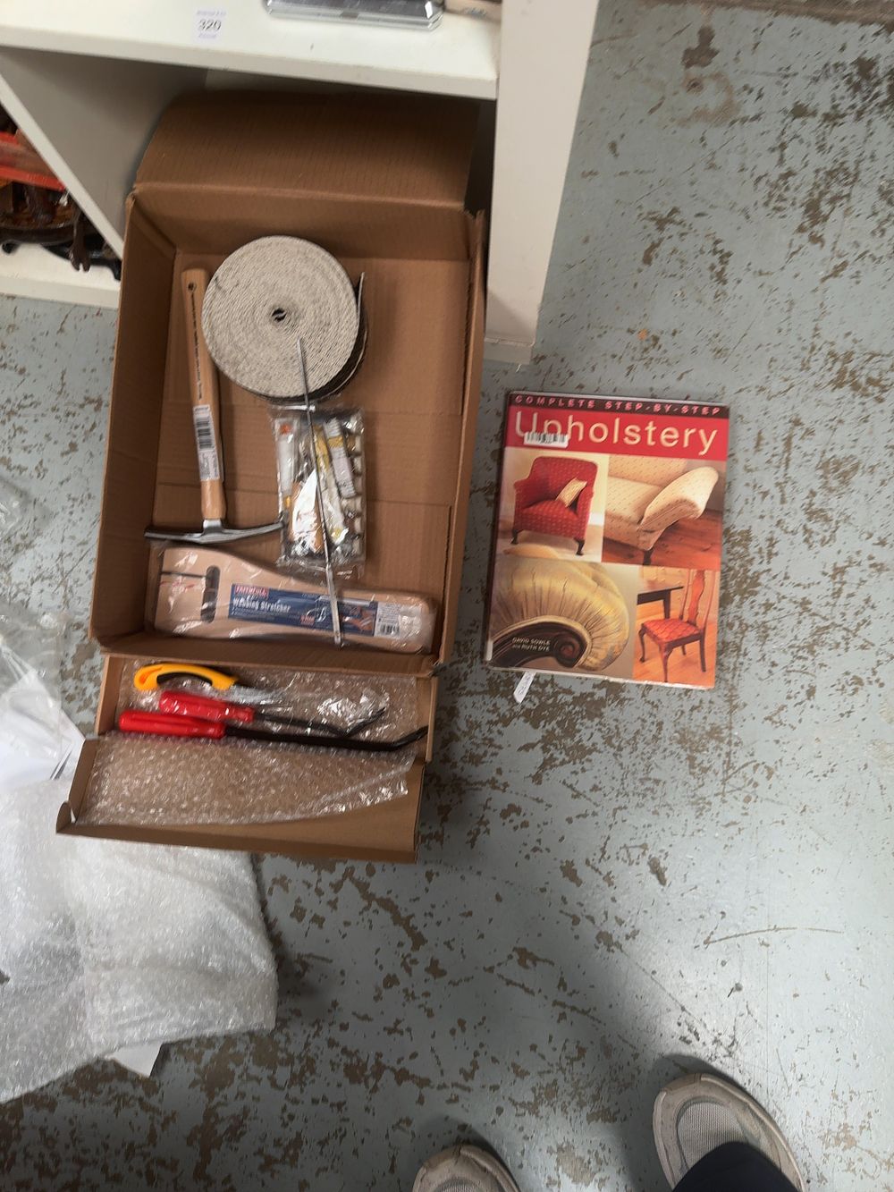 Lot 321: A Collection of Upholstery Tools and Materials including a Faithfull Webbing Stretcher and Instructional Book