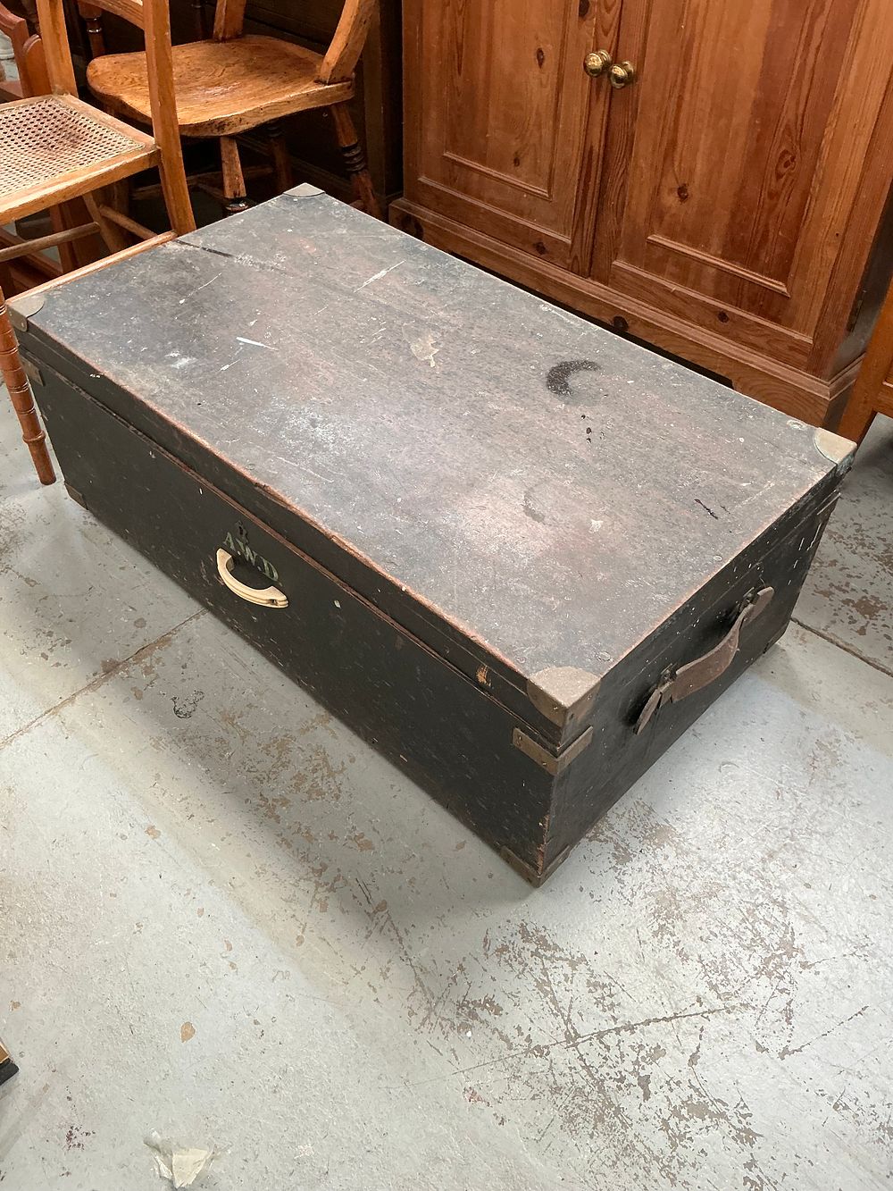 Lot 382: Late 19th or Early 20th Century Pine Travel Trunk with Painted Initials and a solid wood coffee table.