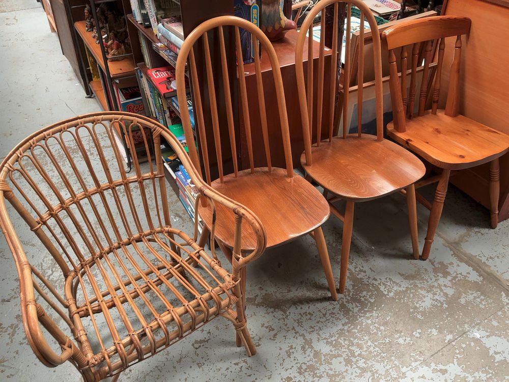 Lot 323: An Assortment of Four Odd Chairs including a Pair of Mid-Century Hoop-Back Dining Chairs, a Rattan Armchair and a Pine Kitchen Chair