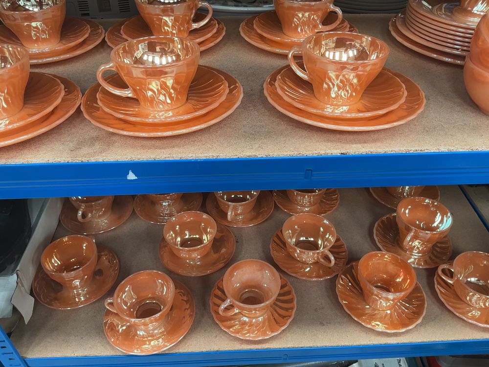 Lot 179: A Collection of Fire-King Peach Lustre Swirl and Laurel Pattern Glass Tableware