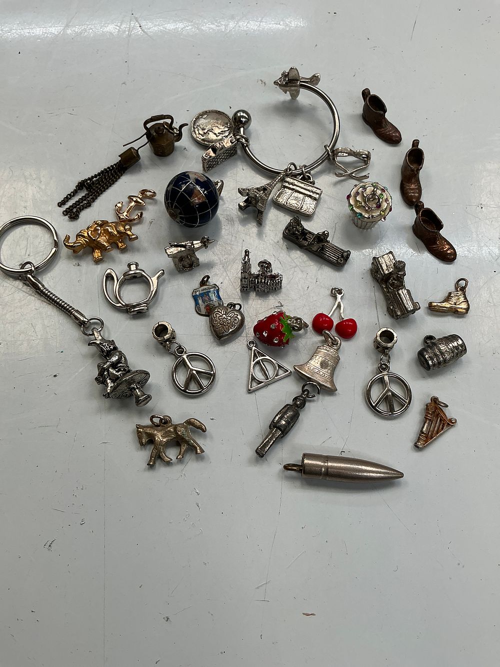 Lot 249: An Assortment of Vintage Silver-Toned and Enamel Charms and Trinkets