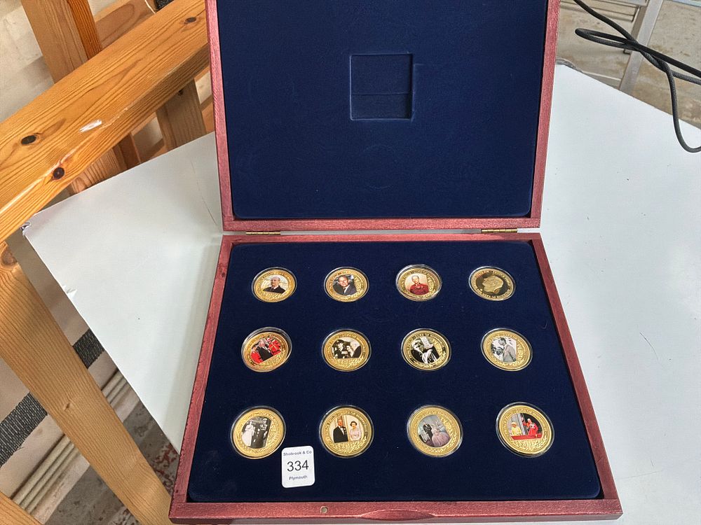 Lot 334: A Collection of Twelve UK Prince Philip Duke of Edinburgh Commemorative Gold-Plated Medallions