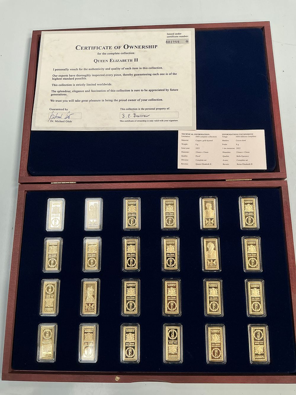 Lot 339: A Windsor Mint Queen Elizabeth II Twenty Four Commemorative Gold-Layered Ingot Collection in Case.