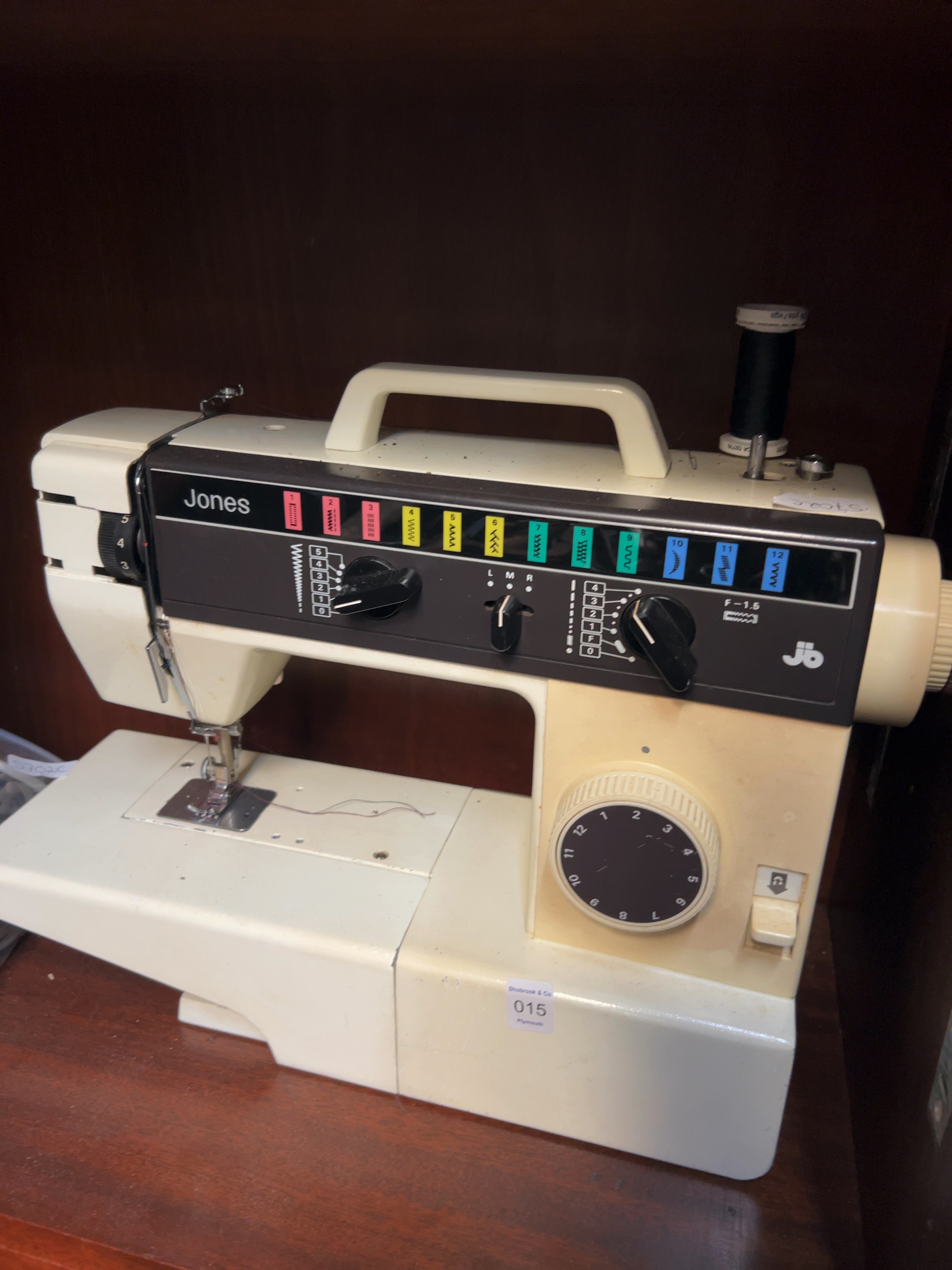 A Mixed Lot comprising a Jones Electric Sewing Machine and an Assortment of Accessories