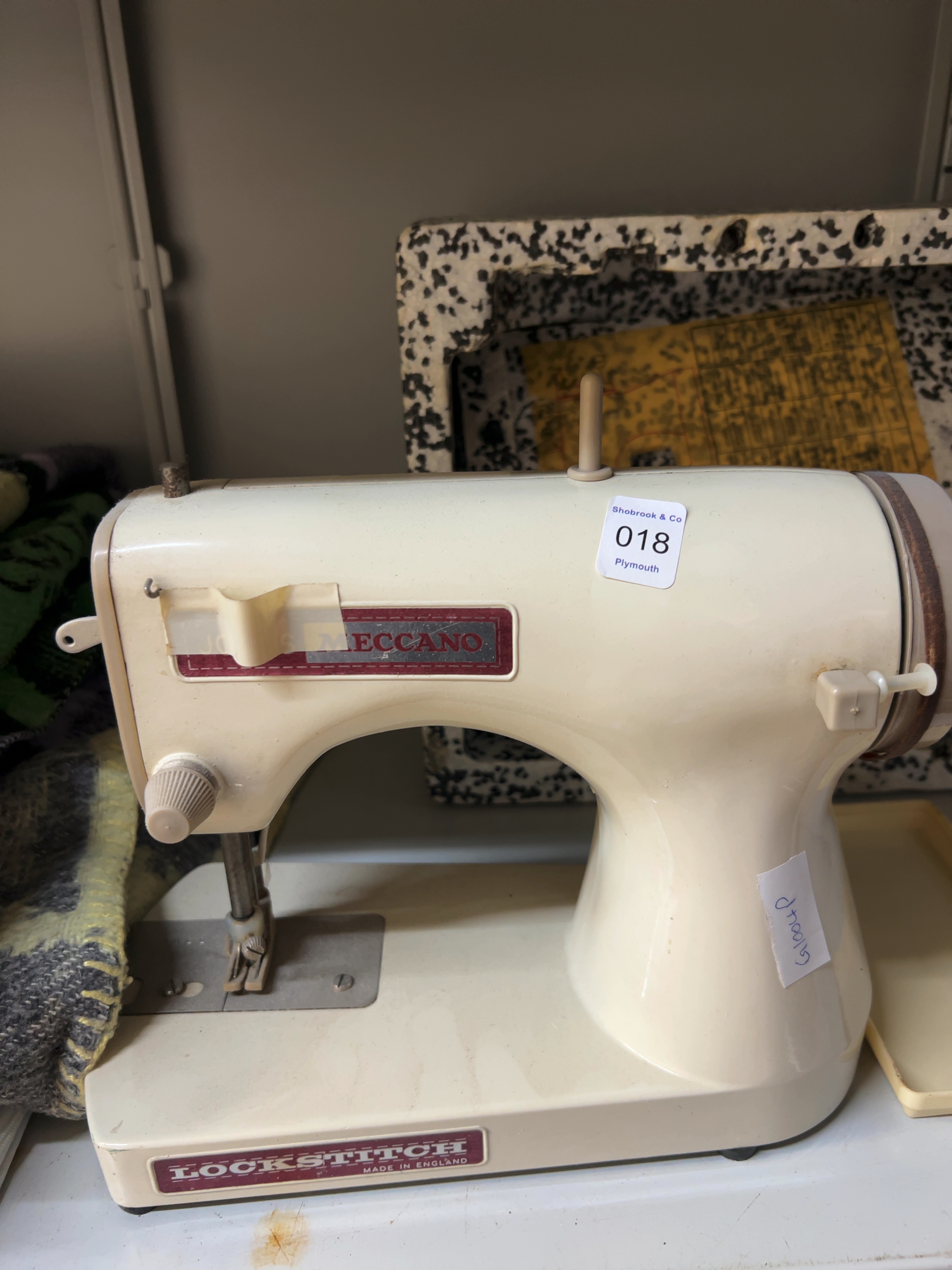 A Vintage Jones Meccano Plastic and Metal Lockstitch Toy Sewing Machine with Original Packaging Insert and Instructions, two blankets and material.