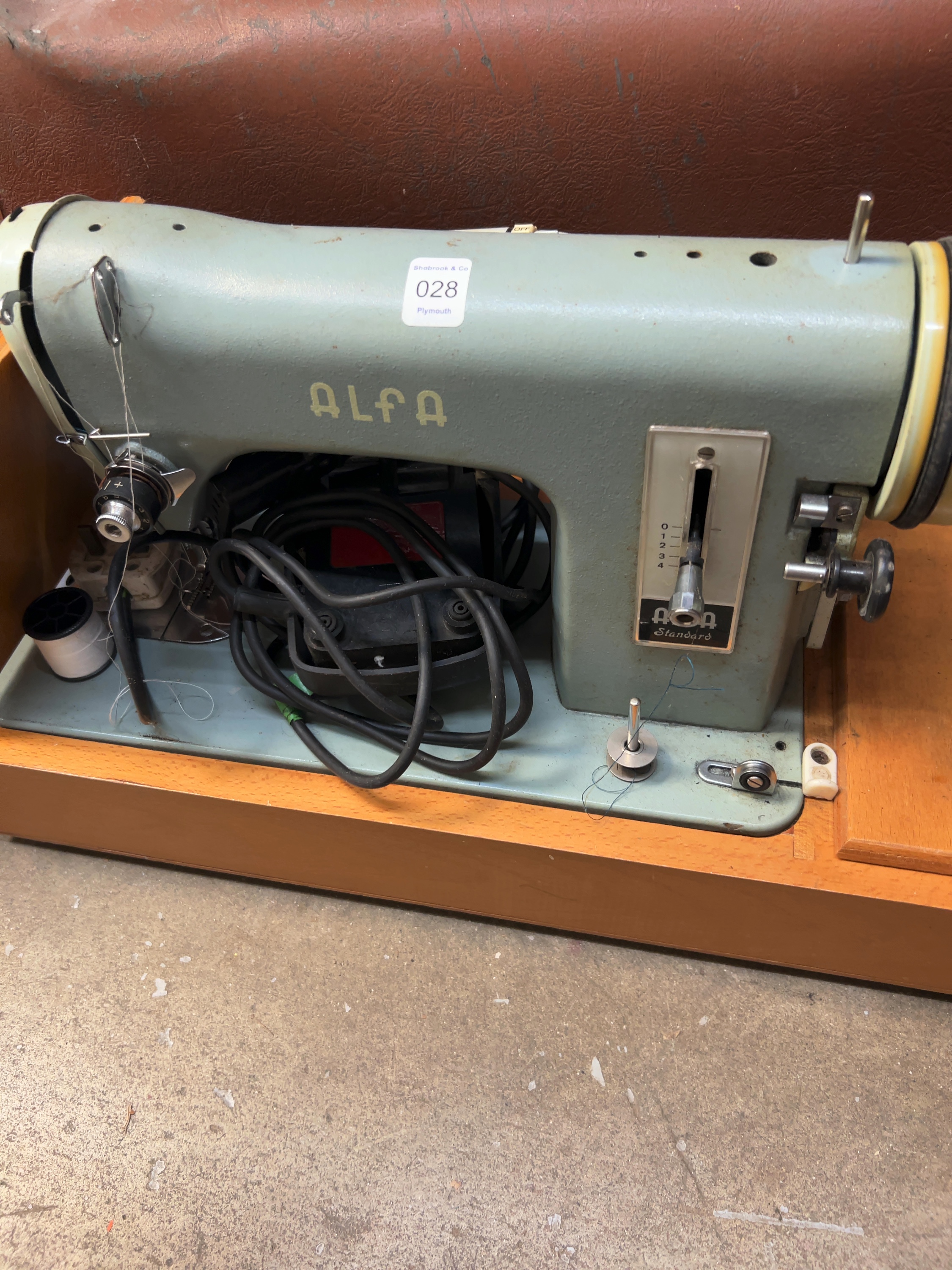 An Alfa Standard Cast Metal Portable Electric Sewing Machine in Case