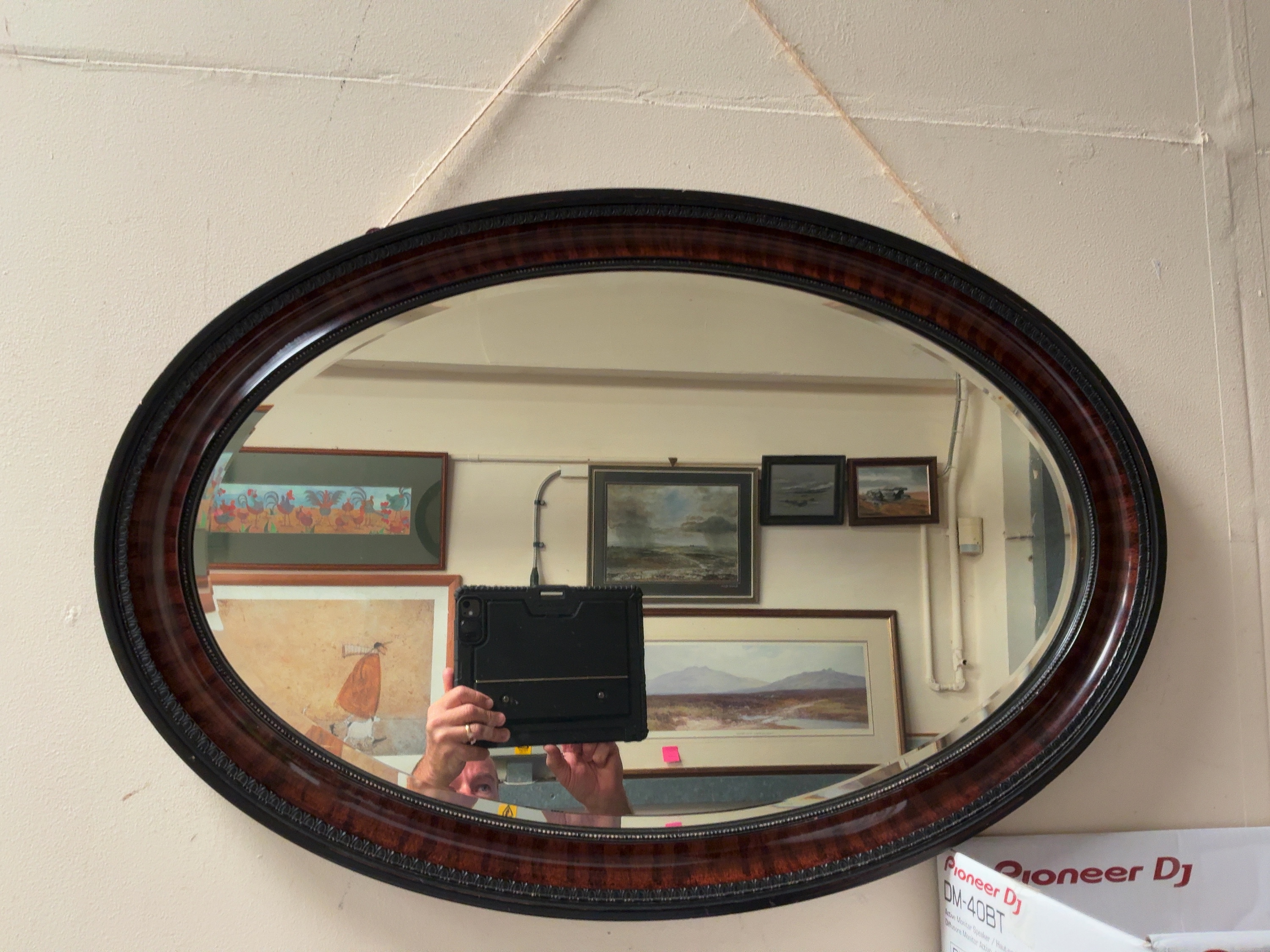 An Edwardian Style Simulated Flame Mahogany and Ebonised Oval Wall Mirror