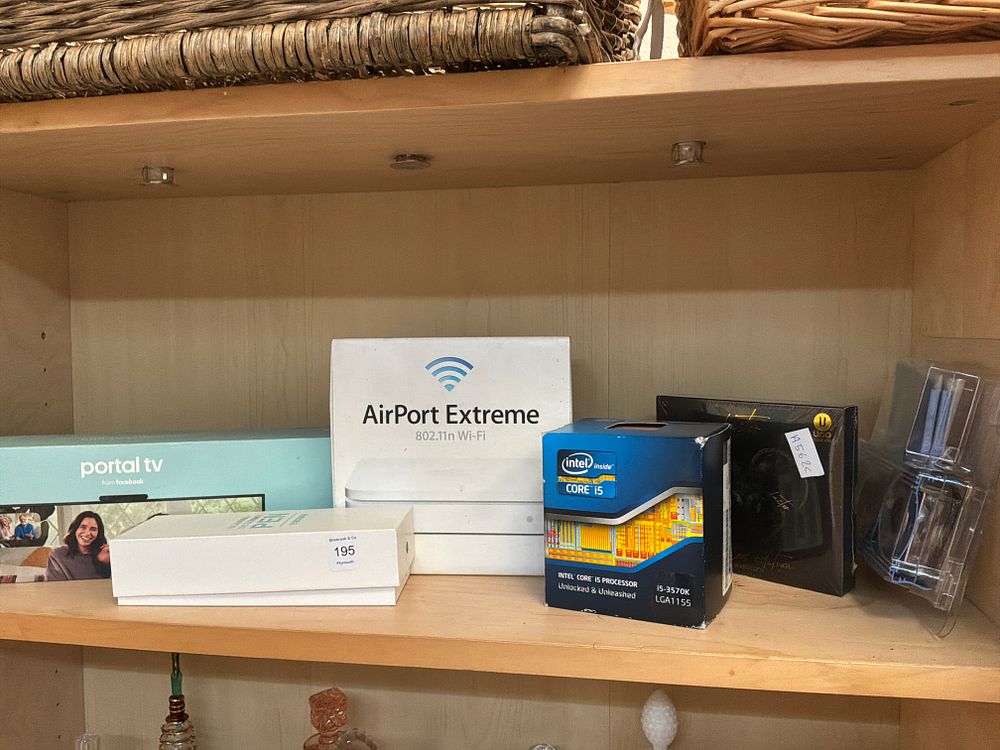 Lot 195: An Assortment of Boxed Consumer Electronics and Computer Components Including Apple and Intel Examples