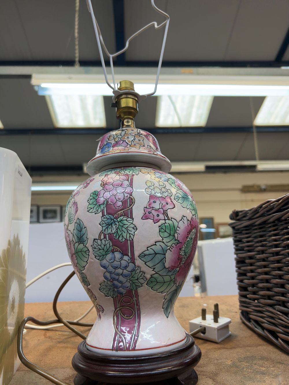 Lot 240: An Oriental Style Polychrome Ceramic Table Lamp with a Matching Lid and Wooden Base, a Pair of modern table lamps and a wicker hamper.