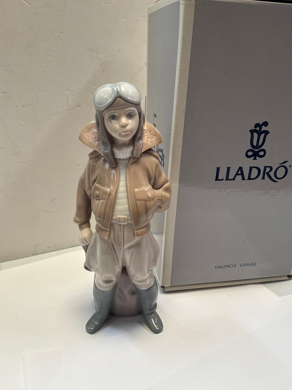 Lot 247: A Lladró Glazed Porcelain Figurine Titled Little Pilot with Original Presentation Box