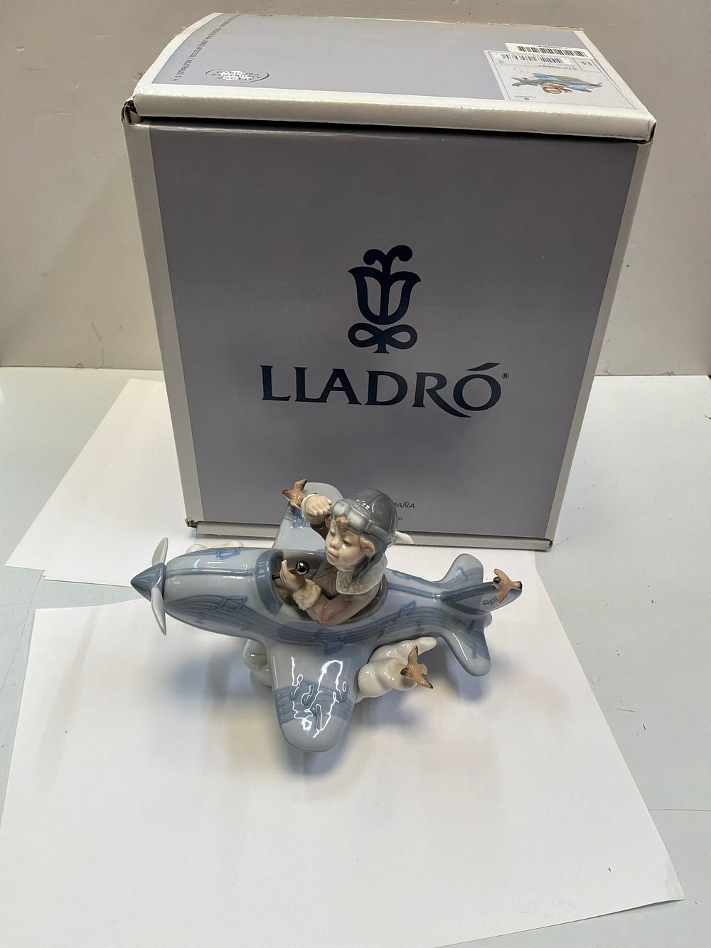Lot 248: A Lladró Over the Clouds Glazed Porcelain Figurine with Presentation Case