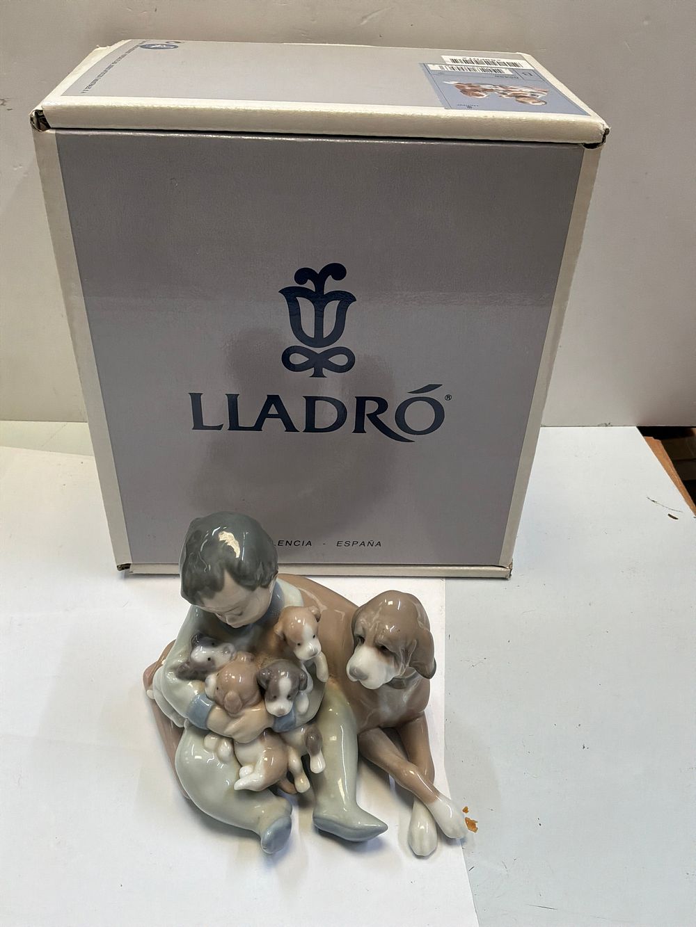 Lot 256: A Lladró Glazed Porcelain Figurine Titled New Playmates with Presentation Case