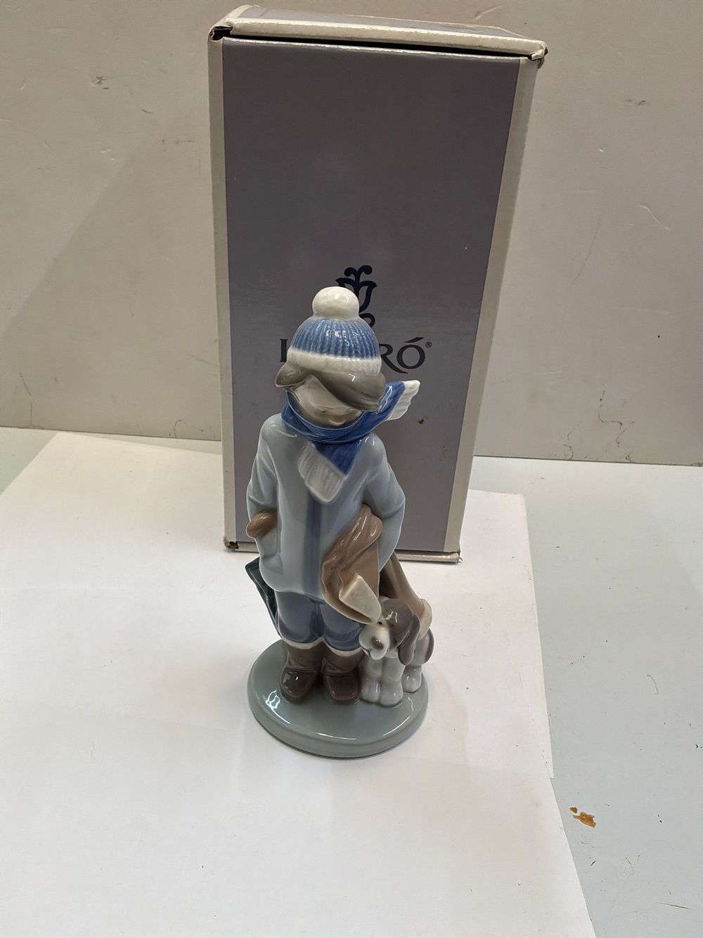 Lot 258: A Lladró Glazed Porcelain Figurine Titled Winter Depicting a Boy and Dog with Presentation Case