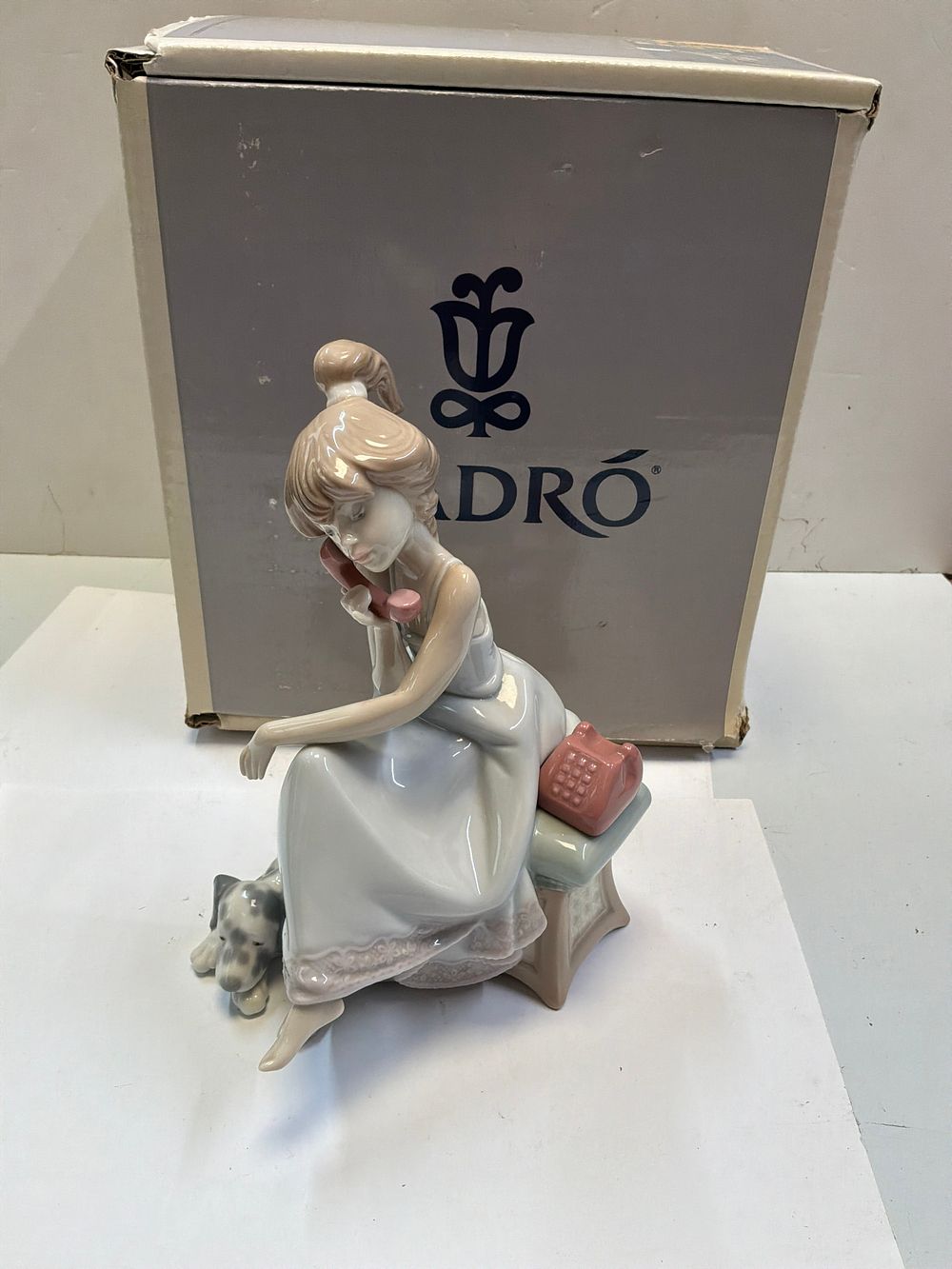 Lot 266: A Lladró Glazed Porcelain Figurine Titled Chit-Chat Model 5466 with Original Retail Box