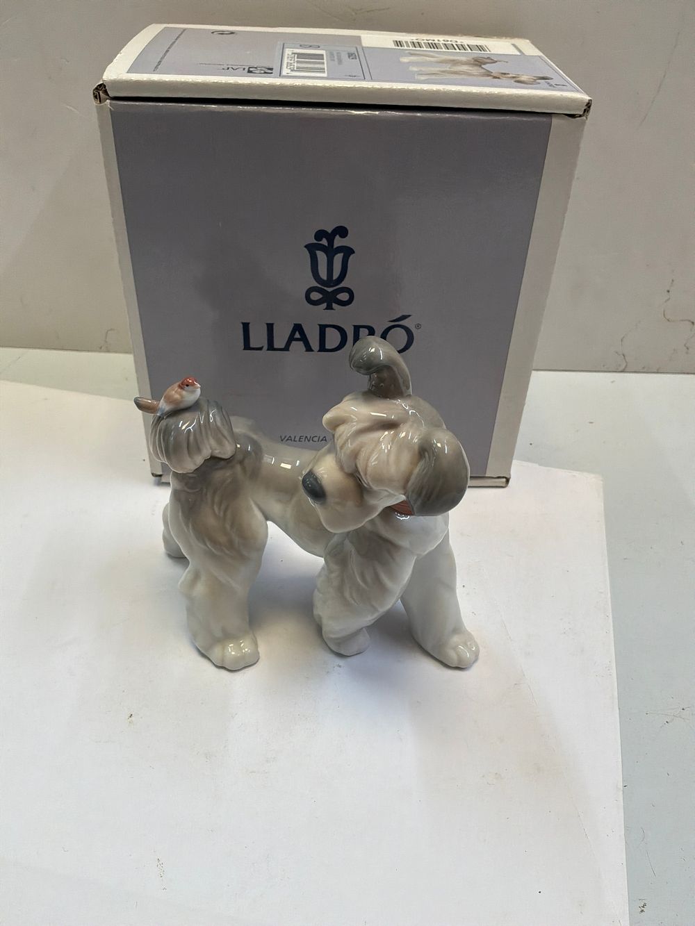 Lot 270: A Lladró Glazed Porcelain Unexpected Visit Schnauzer Dog Figurine with Presentation Case