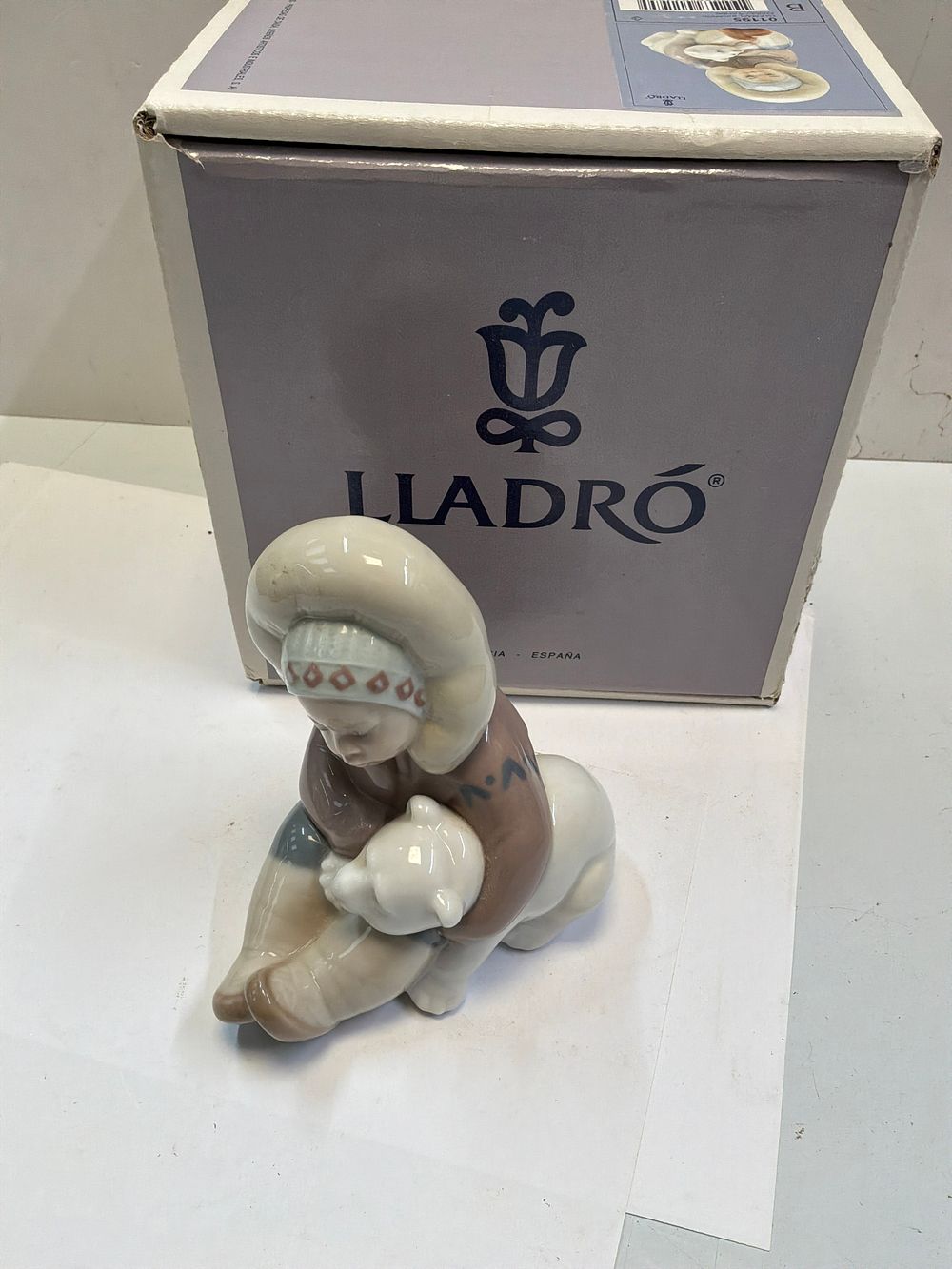 Lot 275: A Lladró Glazed Porcelain Figurine Titled Eskimo Playing with Original Presentation Box
