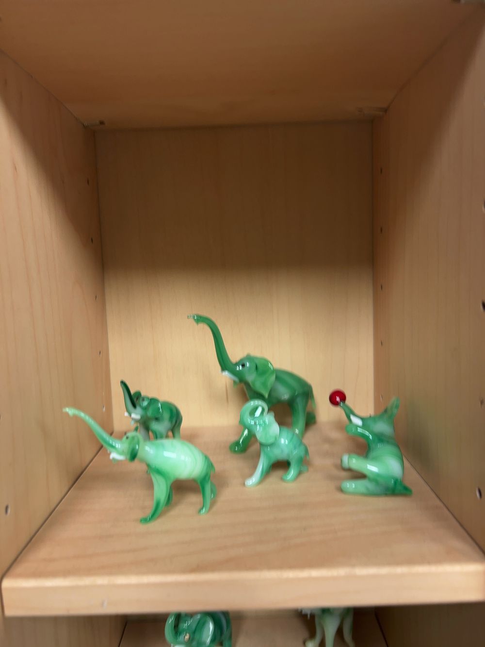 Lot 305: A Collection of Miniature Swirled Green Glass Elephant Figurines