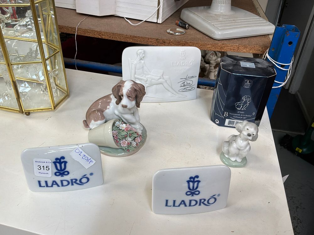 Lot 315: A Collection of Lladró Porcelain Items including Two Figurines and Dealer Display Signs