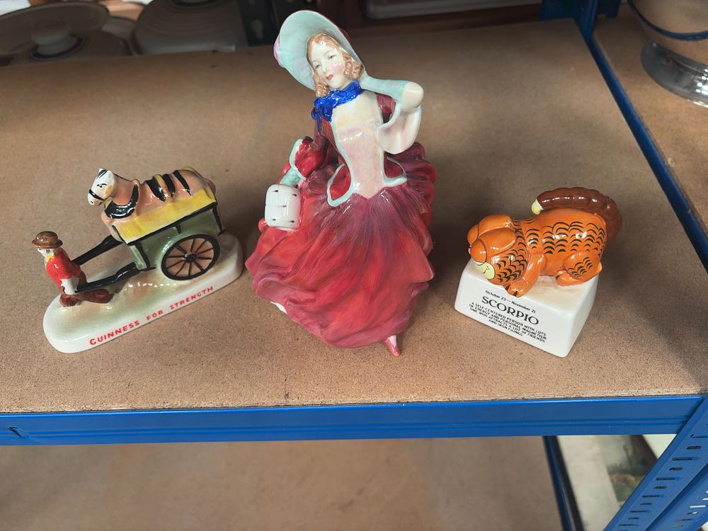 Lot 357: A Trio of Ceramic Figurines Including Royal Doulton, Carlton Ware, and Enesco Examples