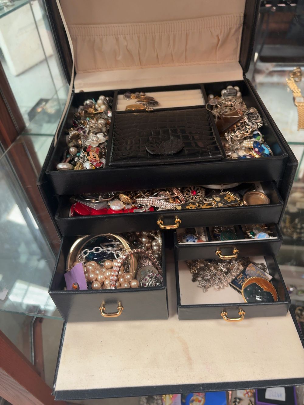 Lot 364: A Collection of Mixed Costume Jewellery in a Multi-Tiered Faux-Leather Box Including Tolkien and Disney style Charms