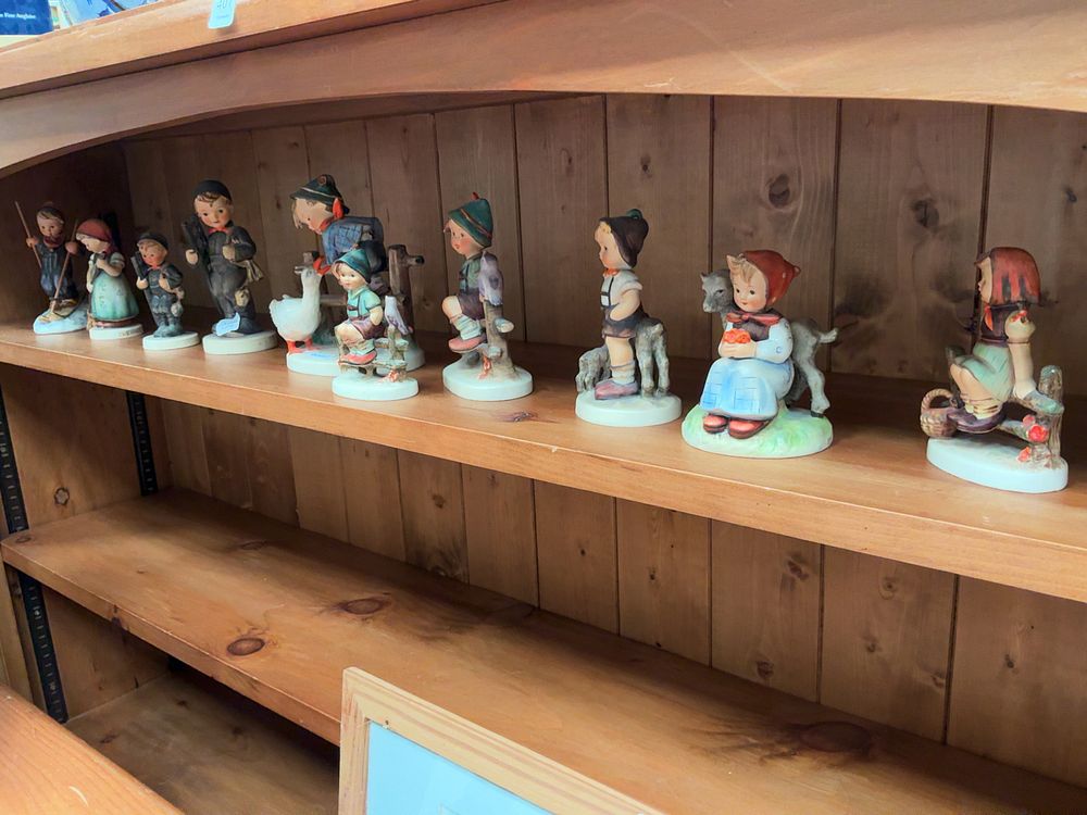 Lot 398: A Collection of Eleven M.J. Hummel Hand-Painted Porcelain Figurines by Goebel