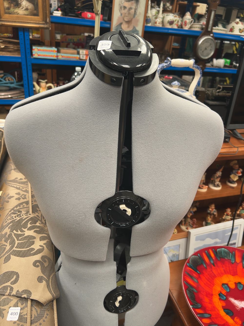 Lot 399_: An Adjustable Grey Fabric Covered Female Dressmaker's Mannequin with Four-Legged Stand
