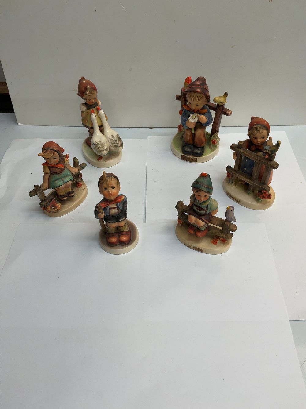 Lot 473: A Collection of Six West German Goebel M.I. Hummel Earthenware Figurines including Signs of Spring