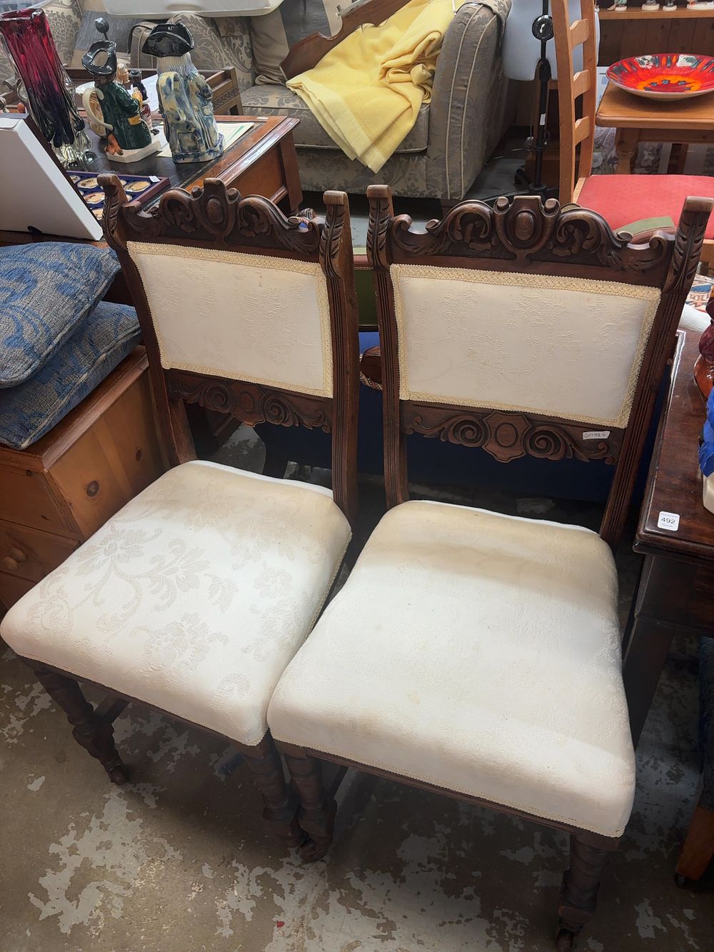 Lot 496: A Pair of Two Victorian style Carved Dark Wood Side Chairs with Damask Upholstery