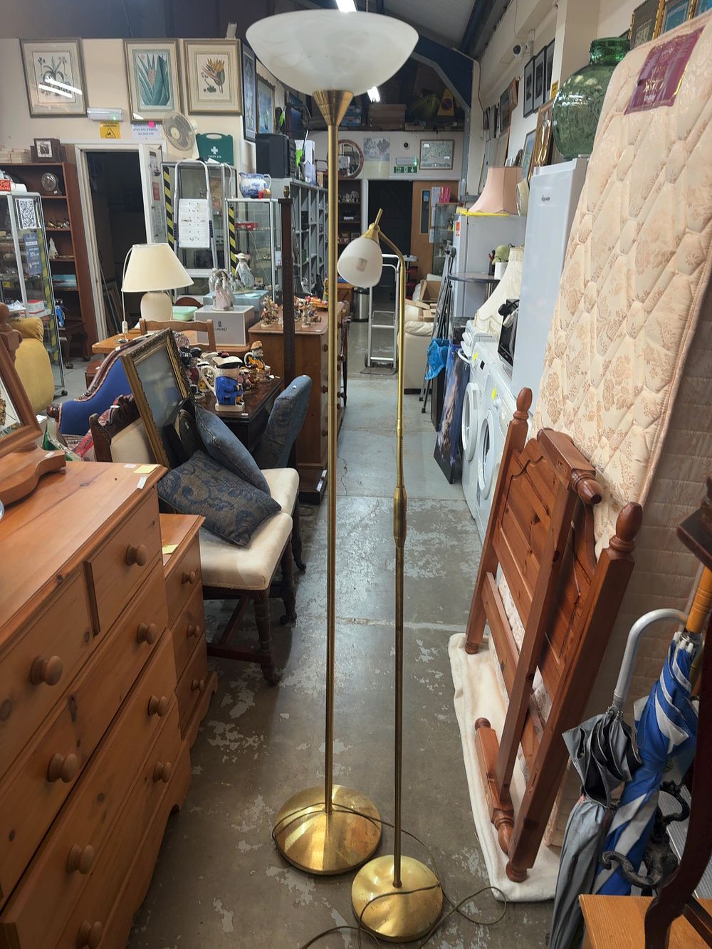 Lot 516: Two Hollywood Regency Style Brass-Effect Metal Floor Uplighters