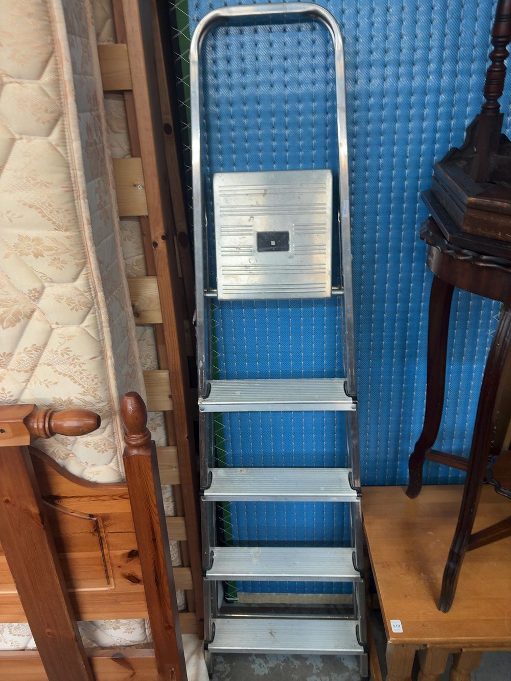 Lot 522: A Four-Step Aluminium Folding Utility Ladder with Integrated Safety Rail