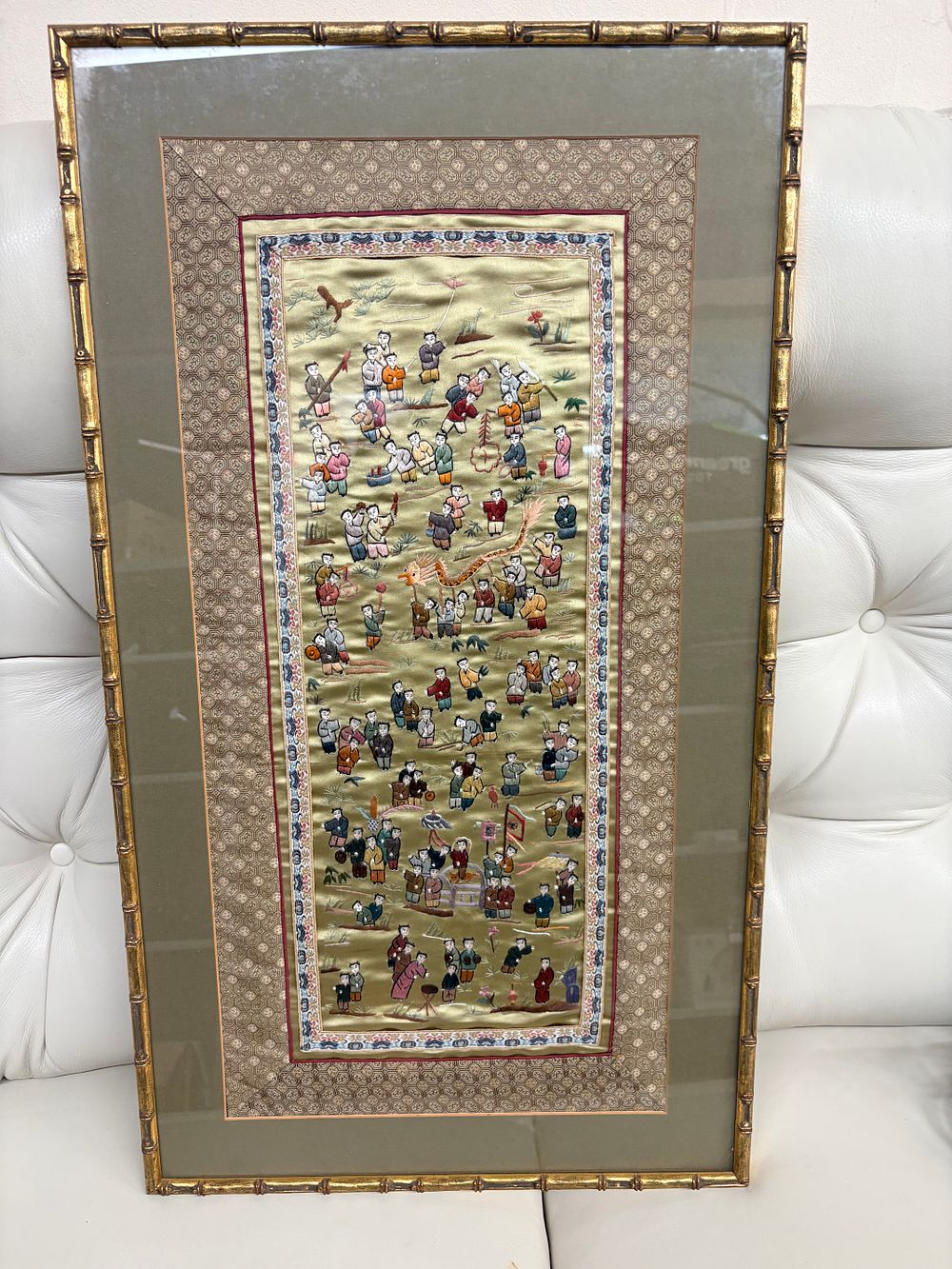 Lot 530: A Framed Late Qing Dynasty style Chinese Silk Embroidered Panel Featuring a Hundred Boys Festive Motif