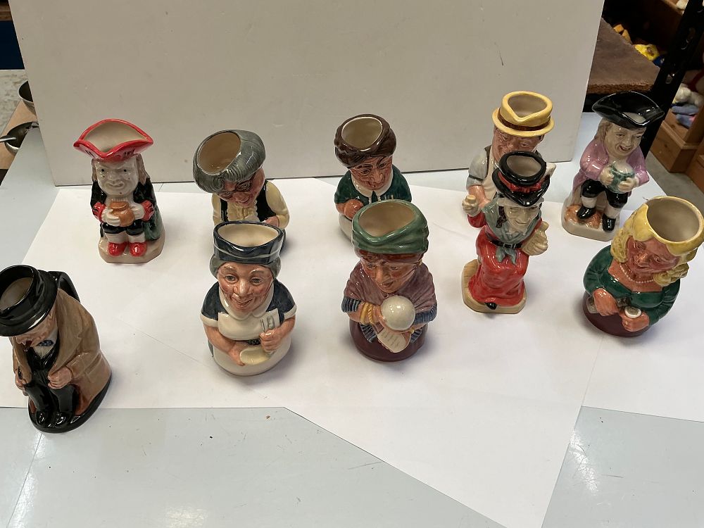 Lot 559: A Collection of Twelve Royal Doulton Ceramic Character Jugs Including Winston Churchill and Doultonville Examples