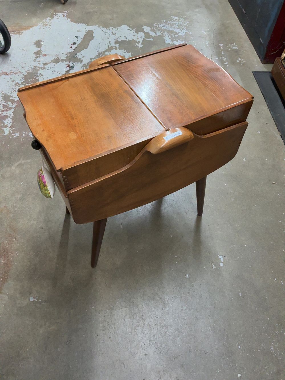 Lot 20: A Mid-Century Modern style Wooden Sewing Table with an Assortment of Sewing Notions