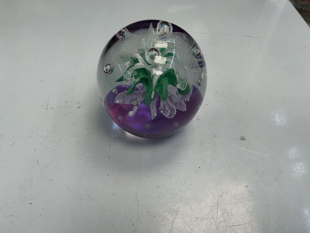 Lot 43: A Lampwork Floral Glass Paperweight with Amethyst Ground and Controlled Bubble Ring