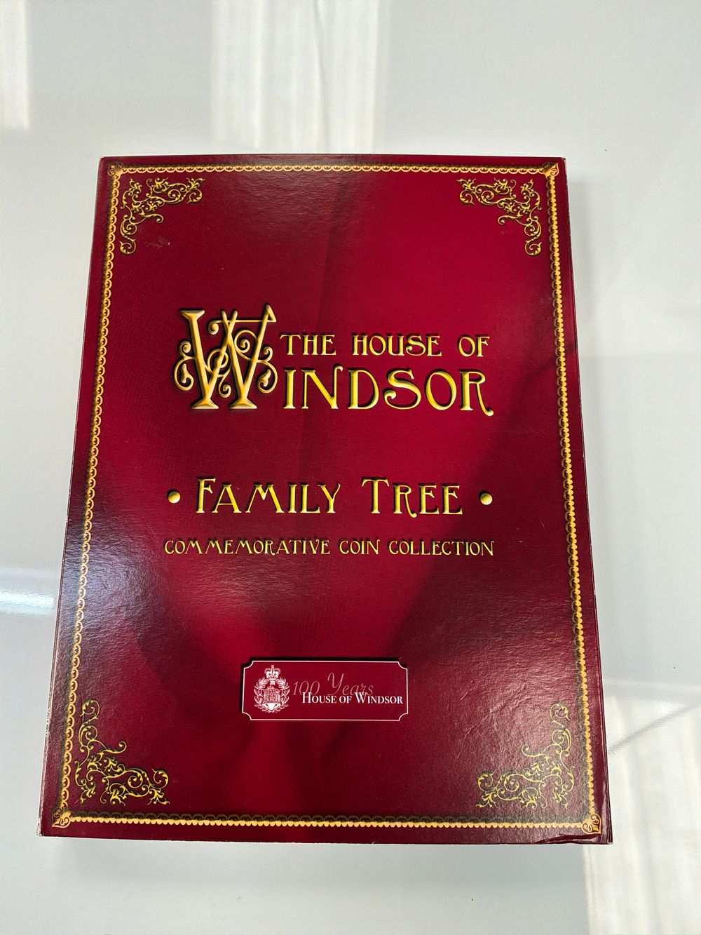 Lot 52: A Set of Eight House of Windsor Commemorative Gold-Coloured One Crown Coins with Presentation Folder