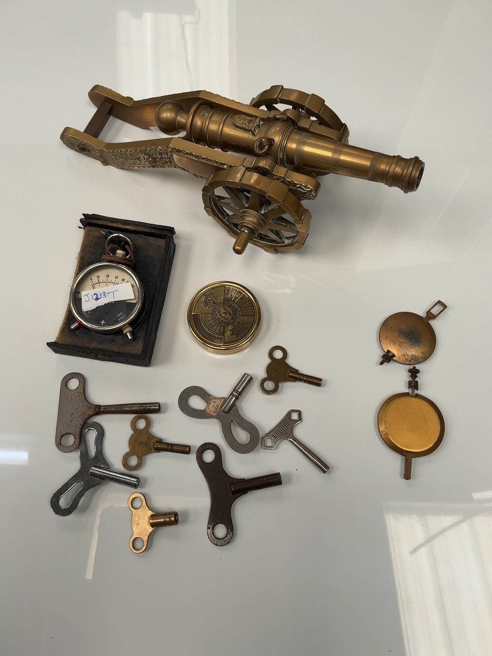 Lot 56: A Collection of Vintage Brass and Metal Items including a Model Cannon, Portable Voltmeter and Clock Winding Keys