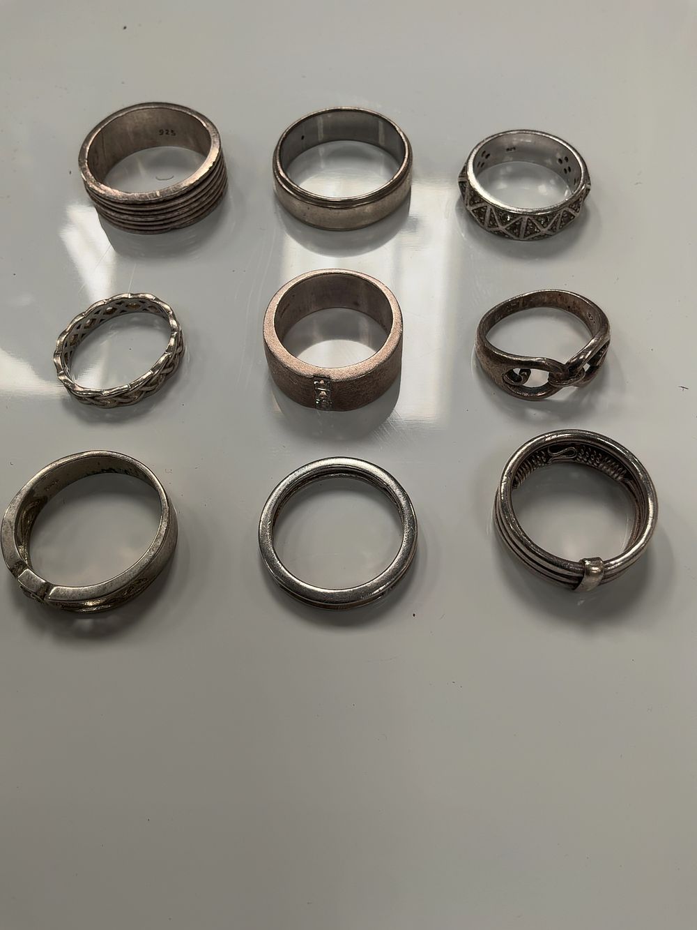 Lot 61: A Collection of Sterling Silver and White Metal Rings in Various Styles