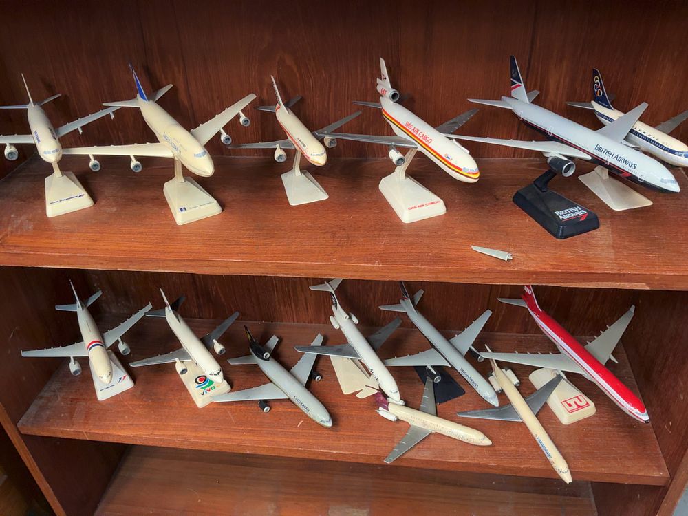 Lot 80: A Collection of Vintage style Plastic and Metal Scale Model Aircraft including British Airways and Air France examples