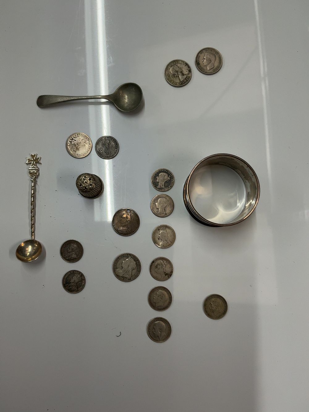 Lot 102: A Collection of Sterling Silver and Silvered Items Including Napkin Ring, Thimble, Spoons, and British and Commonwealth Coins