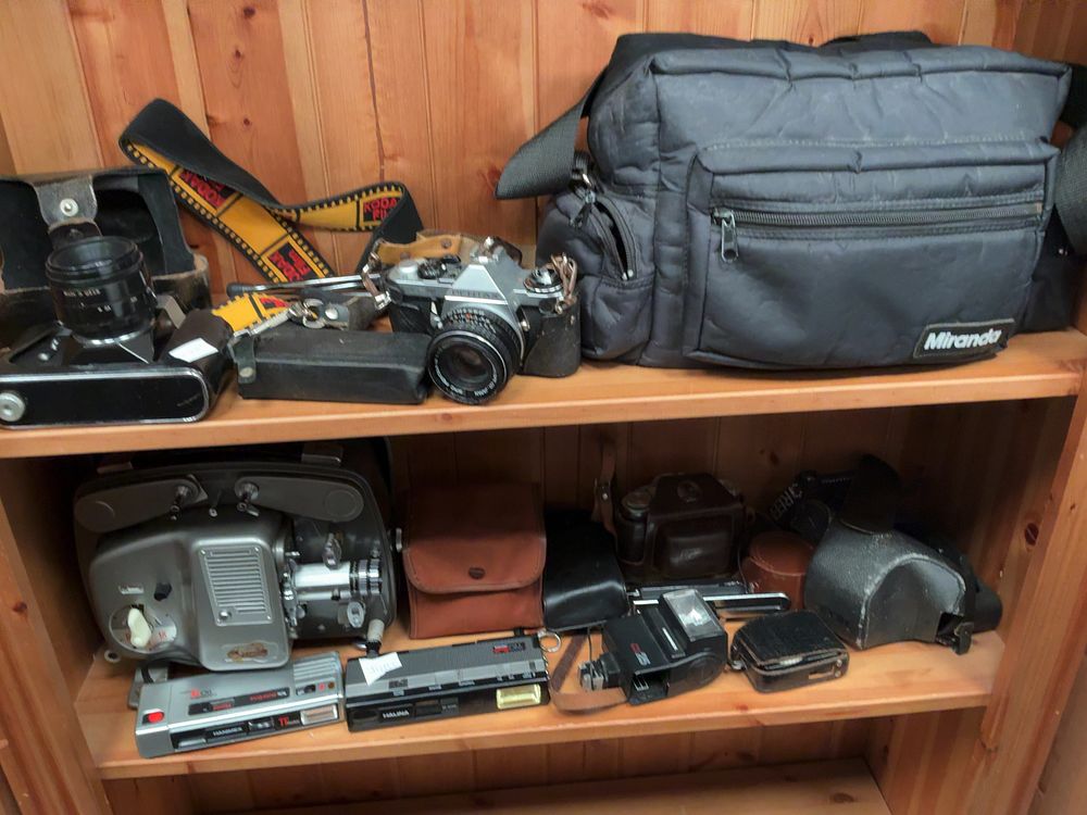 Lot 127: A Collection of Photographic and Cinematographic Equipment Across Two Shelves Including Pentax and Zenit Examples