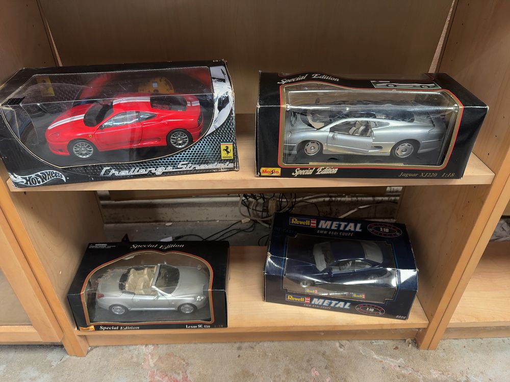 Lot 141: A Collection of Four 1:18 Scale Model Cars Including Hot Wheels Maisto and Revell Examples in Original Packaging