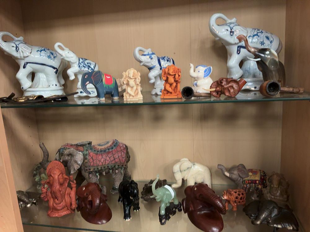 Lot 145: A Collection of Various Elephant and Ganesha Figurines in Ceramic, Stone and Wood style Materials Including Pipes