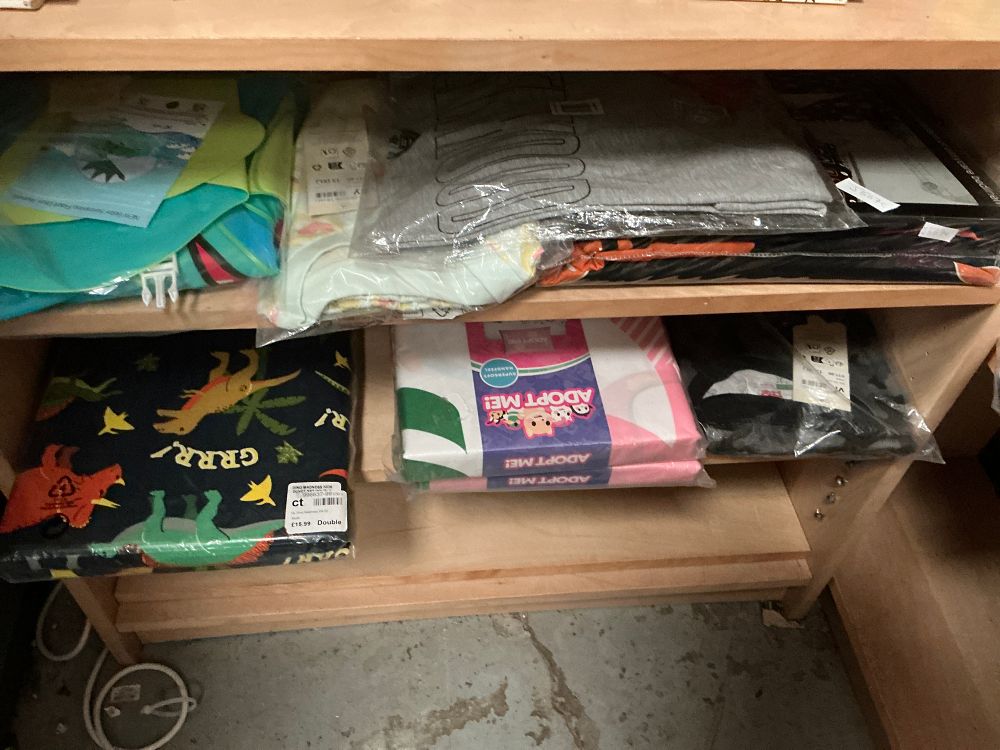 Lot 150: An Assortment of Modern Household Textiles and Childrens Clothing Including Manchester United and Adopt Me Examples