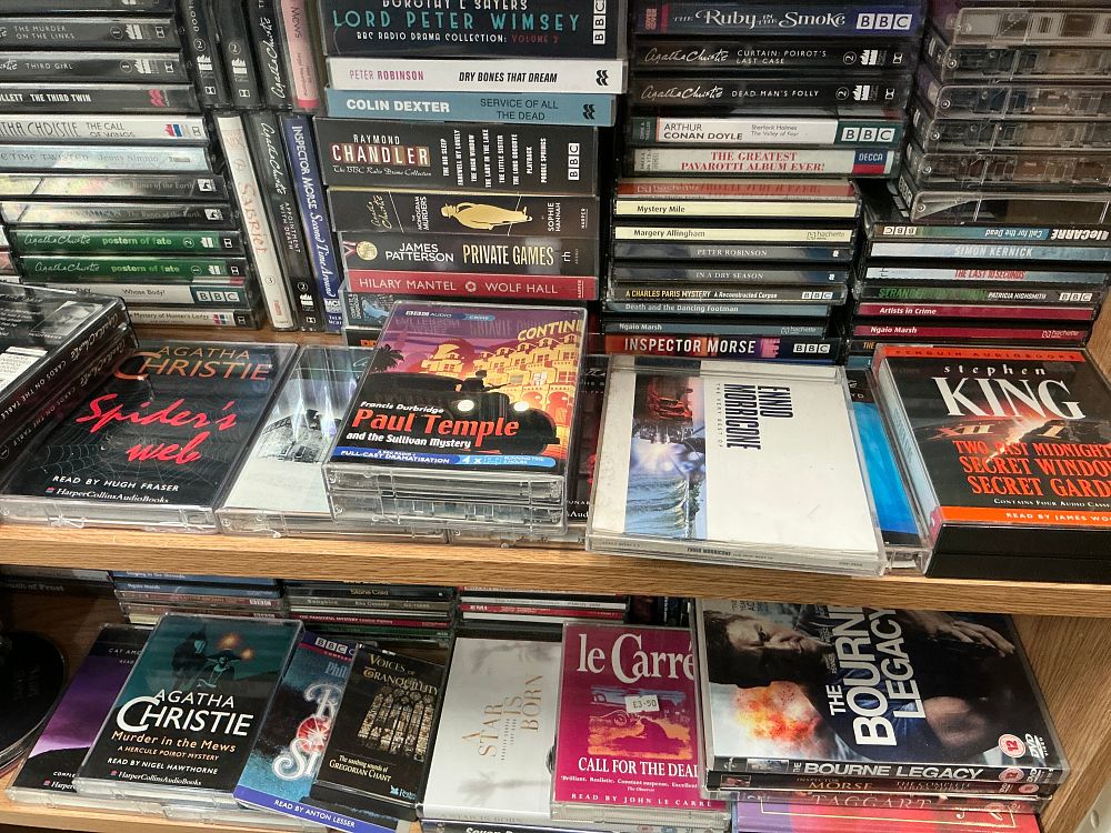 Lot 154: A Collection of Plastic and Cardboard Home Media including Spoken Word Audiobooks, Music CDs, and DVDs