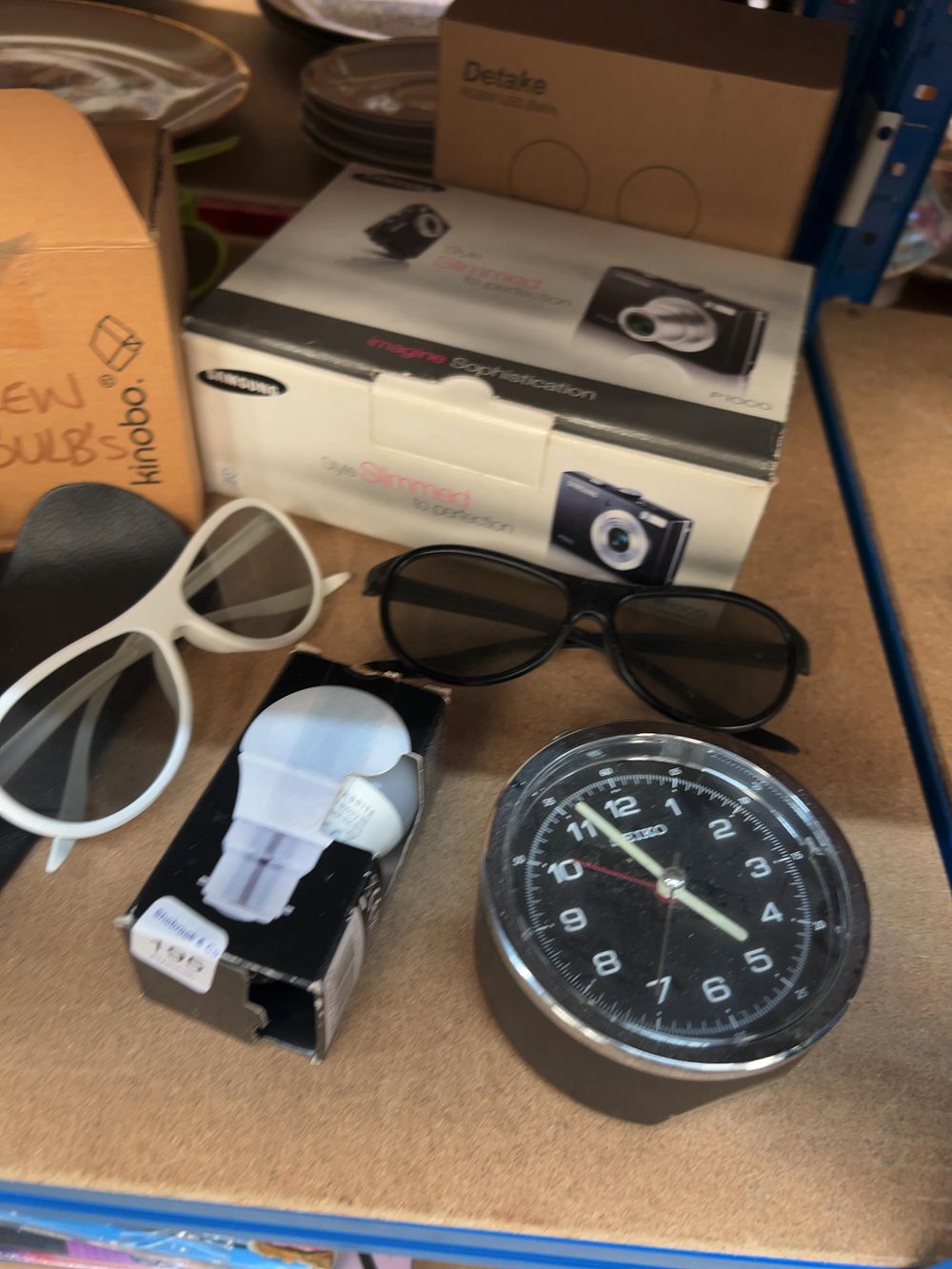 Lot 195: An Assortment of Household Sundries and Small Electronics Including Samsung, Seiko, and Rexel Examples