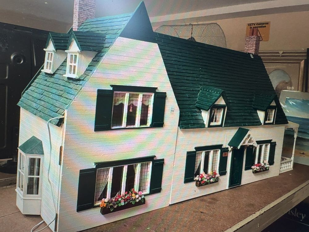 Lot 214: A Colonial Style Wooden Dollhouse with Furnished Interior