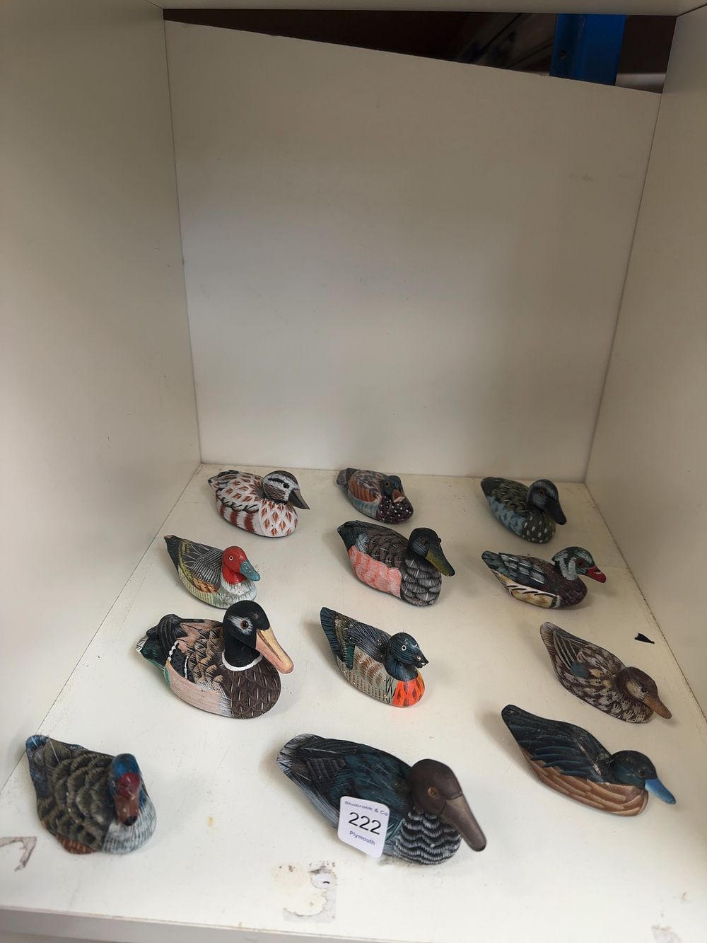 Lot 222: A Collection of Twelve Hand Painted Carved Wooden Miniature Duck Decoys