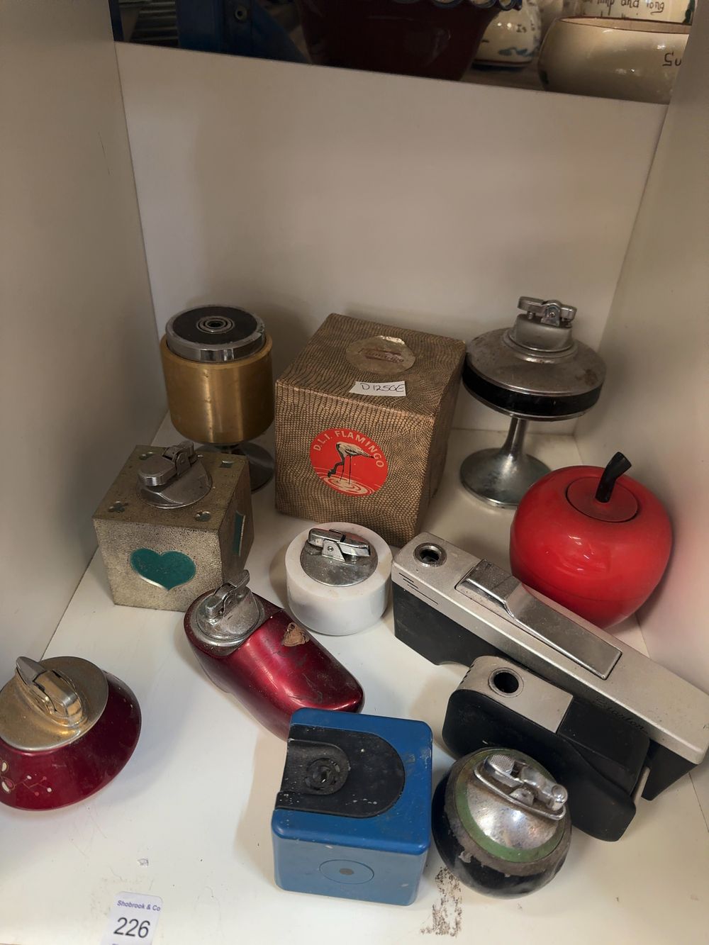 Lot 226: A Collection of Vintage Metal Stone and Plastic Table and Pocket Lighters including Starlon and D.L.I. Flamingo Examples